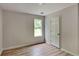 Bedroom features modern flooring, base trim and a double-hung window at 1229 Huntington Place Cir, Lithonia, GA 30058