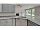 Updated kitchen features granite countertops, stainless steel appliances, and gray cabinets at 1229 Huntington Place Cir, Lithonia, GA 30058