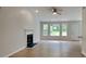 Light-filled living room with a cozy fireplace and large windows overlooking the yard at 1229 Huntington Place Cir, Lithonia, GA 30058