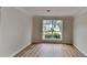 Cozy living room features hardwood flooring and a large window providing natural light at 1229 Huntington Place Cir, Lithonia, GA 30058