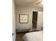 Relaxing bedroom with wainscotting and a comfortable bench and bed at 2135 Niskey Lake Sw Rd, Atlanta, GA 30331