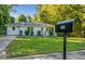 Charming white brick home with a well-manicured front lawn and mailbox at 2135 Niskey Lake Sw Rd, Atlanta, GA 30331
