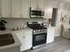 Modern kitchen with stainless steel appliances and white marble countertops at 2135 Niskey Lake Sw Rd, Atlanta, GA 30331