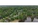 An aerial view shows many houses surrounded by lush greenery and a lake nearby at 2548 Lakeview East Se Trl, Atlanta, GA 30316