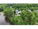 Aerial view of a home with a pool near a lake; lush, mature trees provide privacy at 2548 Lakeview East Se Trl, Atlanta, GA 30316