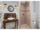 Bathroom with tile shower, custom vanity, unique vessel sink, modern fixtures, and decorative lighting at 2548 Lakeview East Se Trl, Atlanta, GA 30316