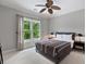 Serene bedroom featuring a ceiling fan, carpet, and a bright window with natural light at 2548 Lakeview East Se Trl, Atlanta, GA 30316