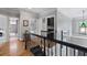 Bright upstairs hallway with hardwood floors and black wrought iron railing at 2548 Lakeview East Se Trl, Atlanta, GA 30316