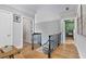 Upstairs hallway with hardwood floors and black wrought iron railing at 2548 Lakeview East Se Trl, Atlanta, GA 30316
