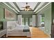 The spacious main bedroom features a tray ceiling, beautiful hardwood floors, and private balcony access at 2548 Lakeview East Se Trl, Atlanta, GA 30316