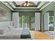 The spacious main bedroom features a tray ceiling, beautiful hardwood floors, and private balcony access at 2548 Lakeview East Se Trl, Atlanta, GA 30316