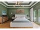 A spacious main bedroom featuring a tray ceiling, hardwood floors, and access to the private balcony at 2548 Lakeview East Se Trl, Atlanta, GA 30316