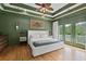 A spacious main bedroom featuring a tray ceiling, hardwood floors, and access to the private balcony at 2548 Lakeview East Se Trl, Atlanta, GA 30316