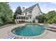 Inviting backyard pool area with stone accents, a covered porch and lush landscaping at 2548 Lakeview East Se Trl, Atlanta, GA 30316