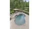 A kidney shaped in-ground pool features a pergola and mature landscaping at 2548 Lakeview East Se Trl, Atlanta, GA 30316