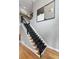 Elegant staircase with black wrought iron railings and dark carpeted steps at 2548 Lakeview East Se Trl, Atlanta, GA 30316