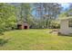 Lush backyard with a storage shed surrounded by mature trees and greenery at 3436 Dodson Ter, Atlanta, GA 30344