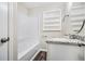 Bathroom featuring a shower-tub combo, granite countertop, and built-in shelving at 3436 Dodson Ter, Atlanta, GA 30344