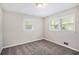 Bright bedroom with two windows, neutral paint, and plush carpeting at 3436 Dodson Ter, Atlanta, GA 30344