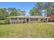 Charming brick ranch home featuring a lush front lawn, black shutters, and a convenient covered carport at 3436 Dodson Ter, Atlanta, GA 30344