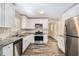 Renovated kitchen featuring stainless steel appliances, granite countertops, and ample cabinet space at 3436 Dodson Ter, Atlanta, GA 30344