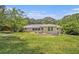 The back of this ranch home features a grassy lawn and a covered patio at 3436 Dodson Ter, Atlanta, GA 30344