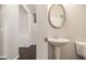 Bathroom showcasing a pedestal sink and dark hardwood floors add a touch of sophistication at 345 Lara Ln, Mcdonough, GA 30253