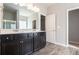 Primary bathroom featuring double vanity, a large mirror and modern fixtures and finishes at 345 Lara Ln, Mcdonough, GA 30253