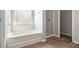 Bathroom with tub, frosted window and glass enclosed shower at 345 Lara Ln, Mcdonough, GA 30253