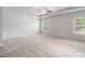 Spacious bedroom with neutral carpet, a ceiling fan and ample natural light from two windows at 345 Lara Ln, Mcdonough, GA 30253