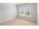 A bright bedroom filled with natural light, featuring cozy carpeting and neutral walls at 345 Lara Ln, Mcdonough, GA 30253