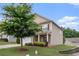Charming two-story home with nice landscaping and manicured lawn on a sunny day at 345 Lara Ln, Mcdonough, GA 30253
