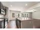 Modern kitchen island featuring granite countertops, stainless steel appliances, and a dining area at 345 Lara Ln, Mcdonough, GA 30253