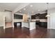 Modern open-concept kitchen with a granite island, stainless steel appliances, and hardwood floors at 345 Lara Ln, Mcdonough, GA 30253