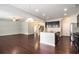 Modern open-concept kitchen with a granite island, stainless steel appliances, and hardwood floors at 345 Lara Ln, Mcdonough, GA 30253