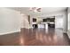 Spacious open-concept living room and kitchen with hardwood floors and stairs leading up to the second floor at 345 Lara Ln, Mcdonough, GA 30253