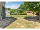Spacious backyard with lush green lawn, mature trees, and a glimpse of the home's exterior at 4850 Wilshire Xing, Cumming, GA 30040