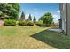 A spacious backyard featuring a well-maintained lawn, mature trees, and a concrete patio for outdoor enjoyment at 4850 Wilshire Xing, Cumming, GA 30040