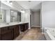 Bright bathroom with a double sink vanity, separate shower, soaking tub, and tile flooring at 4850 Wilshire Xing, Cumming, GA 30040