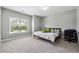 Bright bedroom featuring neutral carpeting, a large window for natural light, and ample space for a desk at 4850 Wilshire Xing, Cumming, GA 30040