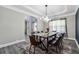 Elegant dining room featuring modern lighting, dining table, and large window creating an ideal space for meals at 4850 Wilshire Xing, Cumming, GA 30040