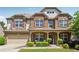 Charming two-story home with brick and stone accents, a well-manicured lawn, and a welcoming front porch at 4850 Wilshire Xing, Cumming, GA 30040