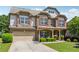 Stately two-story brick home with a two-car garage and manicured landscaping at 4850 Wilshire Xing, Cumming, GA 30040