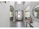 Bright foyer with arched doorways, wood-look flooring, and a front door that leads to a grand two-story entrance at 4850 Wilshire Xing, Cumming, GA 30040