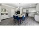 Beautiful kitchen with an island, stainless steel appliances, gray wood floors, and sleek white cabinetry at 4850 Wilshire Xing, Cumming, GA 30040