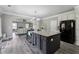 Stylish kitchen with granite countertops, an island with bar seating, and an open layout to the living area at 4850 Wilshire Xing, Cumming, GA 30040