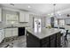 Open-concept kitchen featuring granite countertops, a spacious island, modern appliances, and backyard views at 4850 Wilshire Xing, Cumming, GA 30040