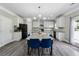 Bright, open kitchen featuring granite counters, white cabinets, modern appliances, and an eat-in area with natural light at 4850 Wilshire Xing, Cumming, GA 30040