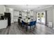A modern eat-in kitchen with granite countertops, stainless steel appliances, a center island, and access to the patio at 4850 Wilshire Xing, Cumming, GA 30040