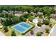 Aerial view of the community tennis courts next to a swimming pool and beautiful homes at 4850 Wilshire Xing, Cumming, GA 30040